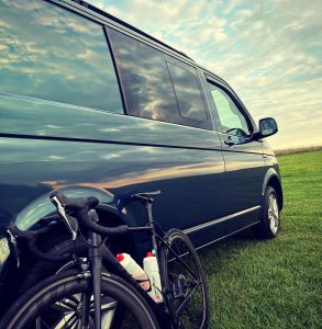 factor bike leaning against the van